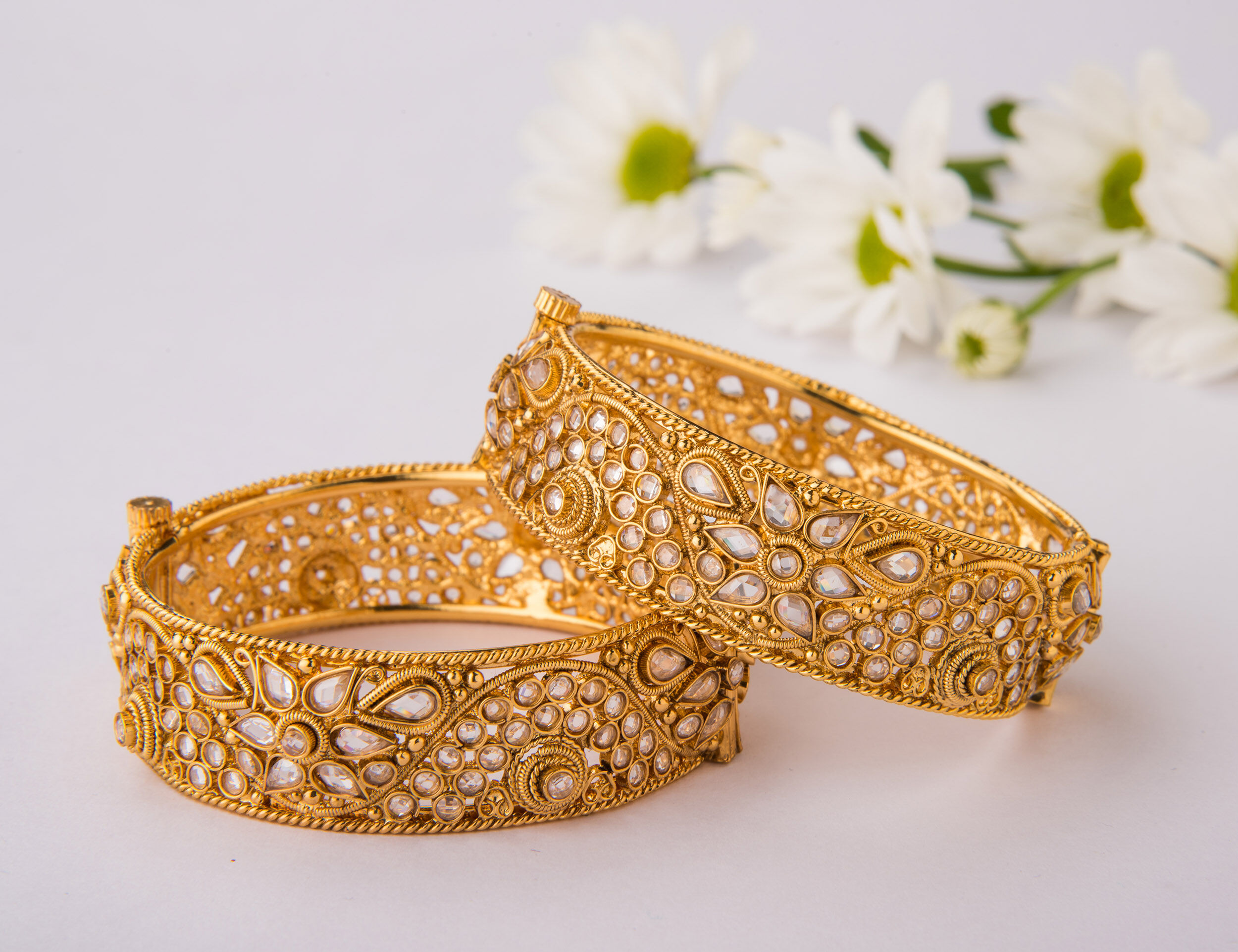 A pair of ornate gold bangles for bride to wear in wedding